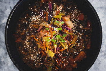 healthy plant-based food, vegan nourish bowl with mexican beans and mixed veggies coleslaw topped with sesame seeds