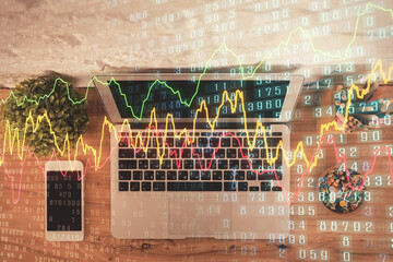 Multi exposure of financial chart drawing over table background with computer. Concept of research and analysis. Top view.