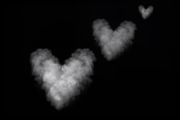 Three white smoke heart shape isolated on black background. Curly smoke for Valentine's Day on a...