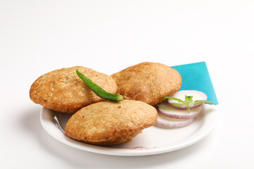 Kachori, green chilly and onion slice in plate. kachori is a spicy snack from India also spelled as...