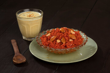 Indian Special Famous Winter Sweet Food Carrot Halwa or Gajar ka Halwa Served With Kesar Masala Milk 