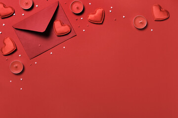 Red envelope, hearts and candles on a red background. Valentine's day romantic concept
