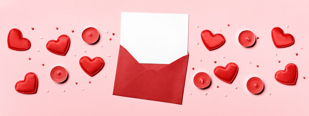 Romantic concept. Valentines day background. Red envelope with blank letter and hearts on pink banner