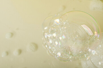 Soap bubbles on the bright beige surface.Empty space
