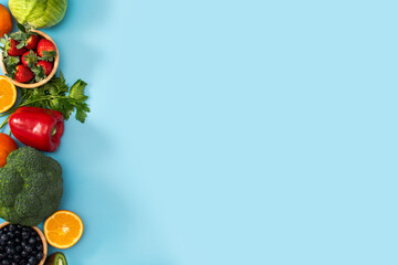 High in vitamin C food on blue background. Top view. Copy space
