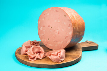 Mortadella Bologna is a large Italian sausage made with cooked pork, mixed with cubes of...