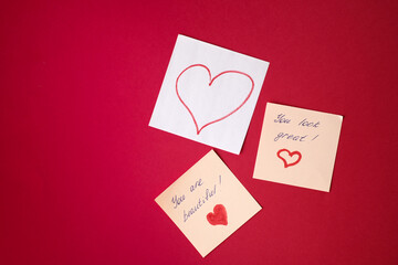 Sticker with love words written by pen, drawn heart and compliments for valentine s day  at red background.