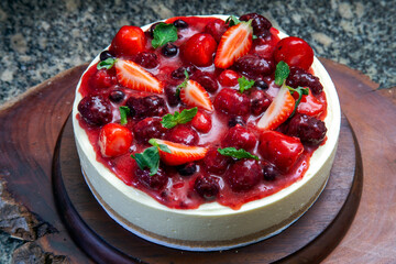Cake with strawberry topping, blackberries with sweet broth