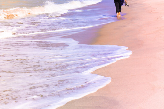 Low Section Of Woman Walking At Beach