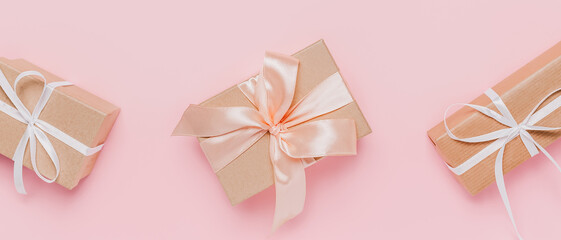 Gifts with wihte ribbon on isolated pink background, love and valentine concept