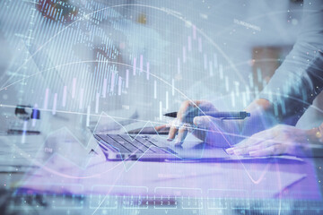 Multi exposure of woman hands typing on computer and financial chart hologram drawing. Stock market analysis concept.