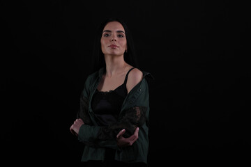 Portrait of beautiful young brunette woman on black background