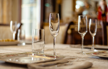 Elegant table set up with chapmagne glasses for dinning room at home. Selective focus