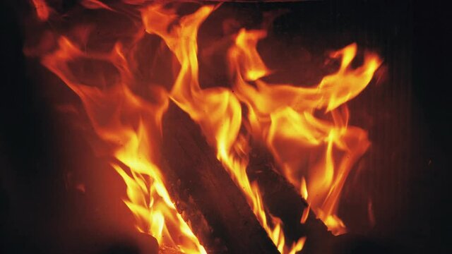 Fire is burning in home fireplace background. Hot flames bonfire in rural house