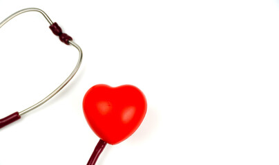 Red heart with stethoscope on white background. Selective focus.Health and Medical concept.	