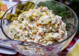 Olivier Salad. Russian salad with variable ingredients, made with chopped vegetables, meat, and...