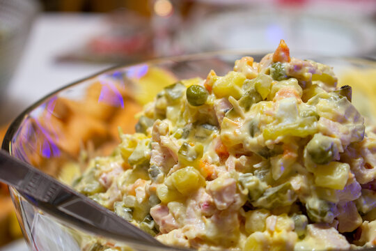 Olivier Salad. Russian salad with variable ingredients, made with chopped vegetables, meat, and mayonnaise.