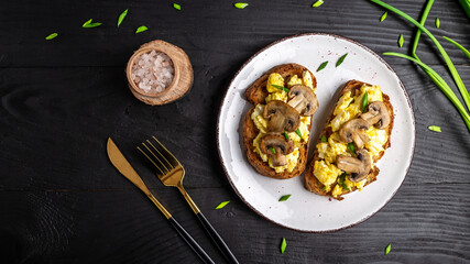 wholewheat toast with scrambled eggs with mushrooms and cottage cheese. healthy breakfast or...