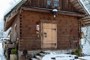 Farm in the forest in winter. Old wooden house under the snow