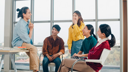 Group of young college students in smart casual wear on campus. Friends brainstorming meeting...
