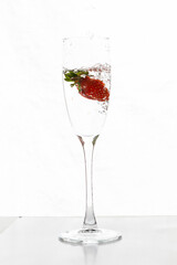 Filling up the champagne glass with strawberry isolated on a white background copy space