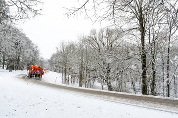 Snow ploughing truck cleans the road