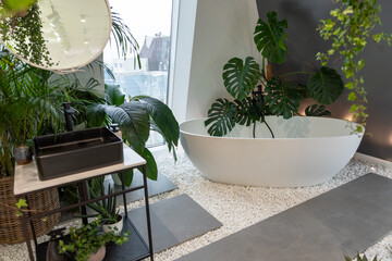 Bright bathroom with subway tiles and a large variety of green potted plants such plant creating a green oasis