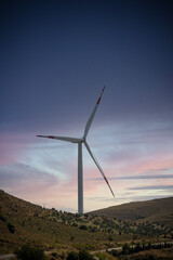 Beautiful wind turbine on the field in sunset time background. Wind Turbines Windmill Energy Farm.