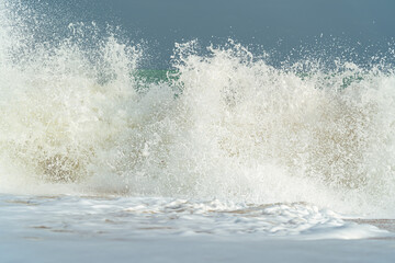 Big waves and surf on a sandy tropical beach