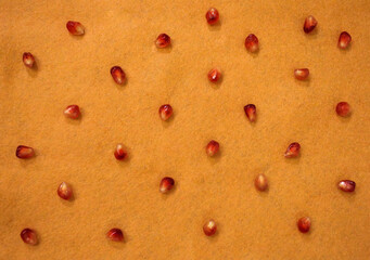 pattern of beautiful ripe pomegranates close-up on an orange background