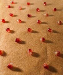 pattern of beautiful ripe pomegranates close-up on an orange background