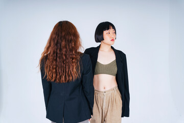 Portrait of two business asian women wearing black jacket suit isolate on white background.