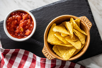 Tortilla chips and red tomato salsa dip. Mexican nacho chips.