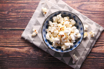  popcorn in a bowl on wooden desk
