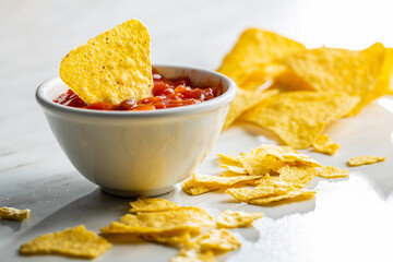 Tortilla chips and red tomato salsa dip. Mexican nacho chips.