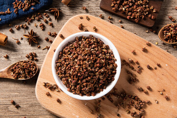 Sichuan pepper isolated on wood background