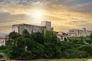 Fototapeta na wymiar medieval castle in village with sunset sky