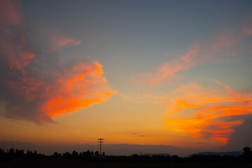 Orange cloudy sunset at the city