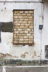 Bricked up window background. Grunge abandoned building. Concrete wall with bricks texture.