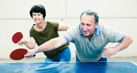 mature couple playing ping pong