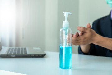 Man hands using wash hand alcohol gel or sanitizer bottle dispenser, against Novel coronavirus or Coronavirus Disease (Covid-19) .