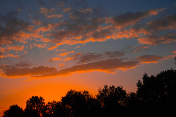 Orange cloudy sunset at the city