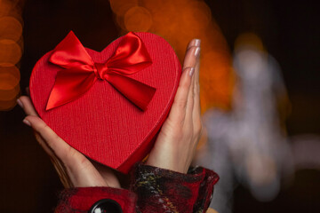 Woman holding a heart shaped Valentine's Day red box