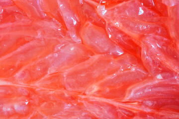 Fresh juicy red grapefruit pulp. Unique macro. Background and backdrop.