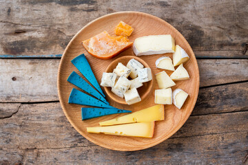 Obraz na płótnie Canvas Top view of set cheese board on wooden background