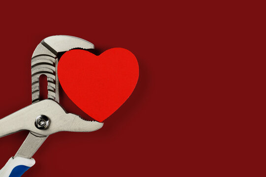 . Wrench with hearts isolated on background. The concept of your favorite profession and Valentine's Day.