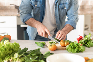 Man preparing delicious and healthy lunch at home kitchen