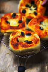 Appetizing mini pizzas on a cooling rack. Homemade mini pizzas. Baking at home.