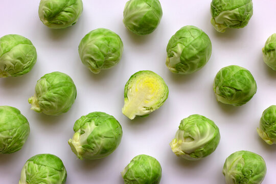 Green brussel sprouts isolated on white background. A pattern from seasonal vegetables. The concept of proper nutrition. Flat lay, copy space.