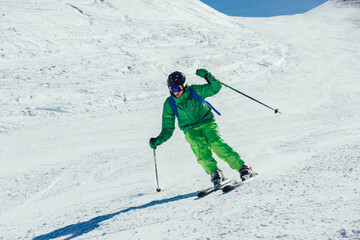 Fototapeta na wymiar Skier in mountains. Professional skier athlete skiing of ski resort.Winter vacation and sport concept.